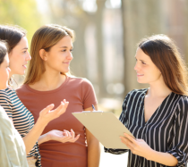 Female colleagues talking in a circle.