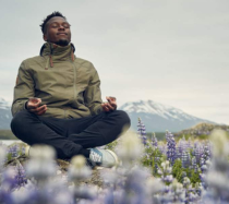 Man meditating in a lilac field.