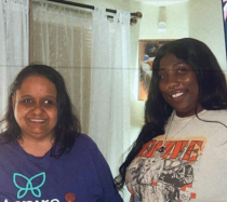 Nelshaun and April, two women with dark brown hair, standing next to each other and smiling.