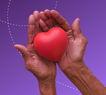 Hands holding a heart to symbolize community giving