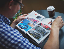 man reading an automobile magazine