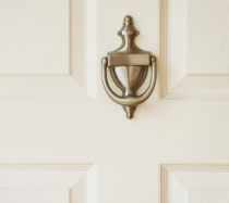 White door with a brass door knocker.