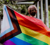 person holding pride flag