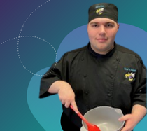 Zach cooking in his chef uniform.