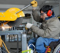 Man working and using a saw.